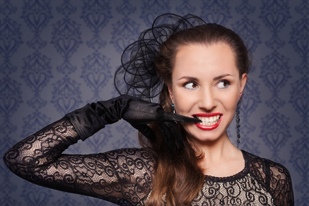 Portrait of young woman in evening make-up, which removes the gloveの写真素材