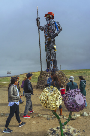 Darkhan, Mongolia - MAY,07 2016: People are photographed near the high sculpture Iron Man, symbol of the city of Darkhanのeditorial素材