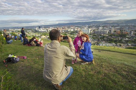 Krasnoyarsk, Russia - September 03 2016: People are photographed against the backdrop of the city at the food festival "Summer Kitchen" on the mountain Pokrovskayaのeditorial素材