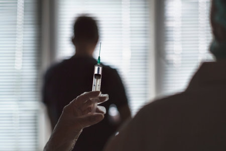 Doctor gives an injection to a patient with a disposable syringe