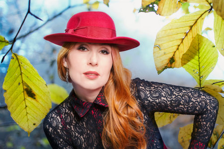Autumn mood of beauty: portrait of a woman in a red hat, photo collage