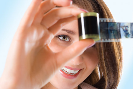 close-ups portrait pretty girl with photo film on blueの写真素材