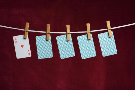 heart ace and four cards with clothes peg rope on red backgroundのeditorial素材