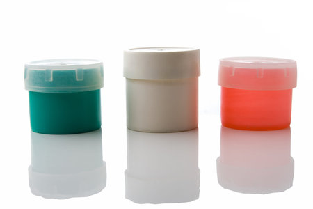 three plastic can over white