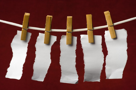 scrap paper attach clothes-peg to rope on venous backgroundの写真素材