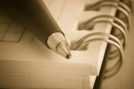 old notebook and pen in sepiaの写真素材