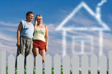 woman and her  boyfiend dream about house  behind fenceの写真素材