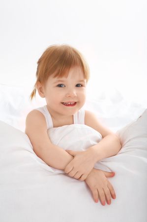 little girl have fun in bedの写真素材