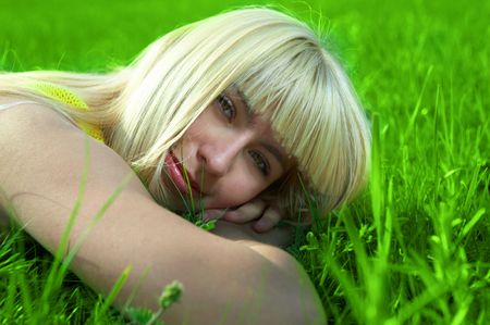 happy  young woman jump in field with green grassの写真素材