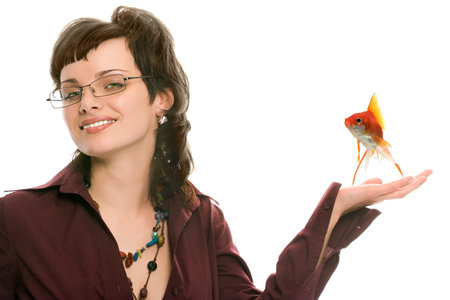 pretty brunette girl in glasses with fish portrait on white backgroundの写真素材