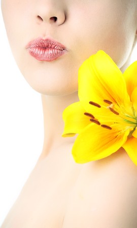 beauty woman with yellow lily on white backgroundの写真素材