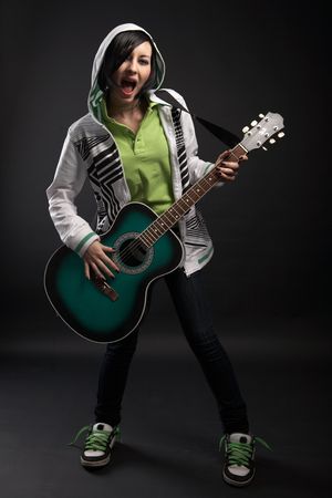 emo girl with guitar on black backgroundの写真素材