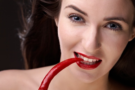 beauty woman with pepper on black backgroundの写真素材