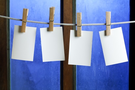 four photo paper attach to rope with clothes pins on window backgroundの写真素材