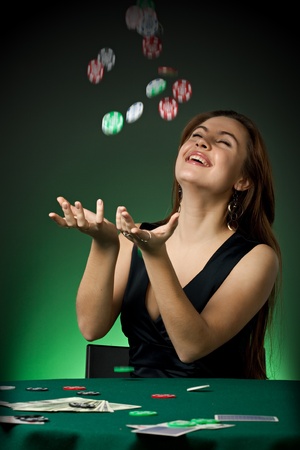 Poker player in casino with cards and chips on green backgroundの写真素材
