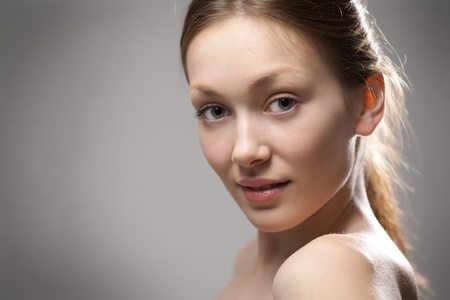 beauty redhaired woman closeup portrait on gray backgroundの写真素材