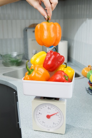 woman hand and pepper and scalesの写真素材