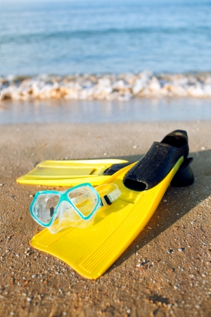 fins lie on the sand near the seaの写真素材