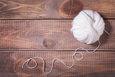 Balls of yarn for knitting on wooden boardsの写真素材