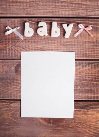 word baby and white frame photo on wood backgroundの写真素材