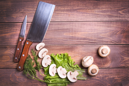 Mushrooms and herbs on a wooden background の写真素材