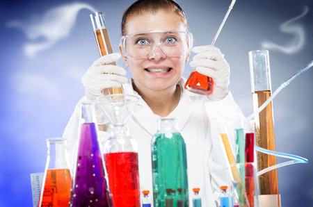 woman scientist in laboratory with glass tubesの写真素材