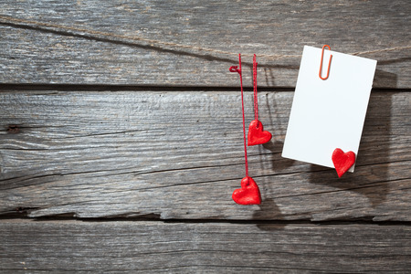 white paper on pins at wood backgroundの写真素材