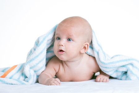 baby in towel on white backgroundの写真素材