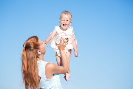 Mather and baby over blue sky