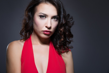 Beautiful young woman in a red dressの写真素材