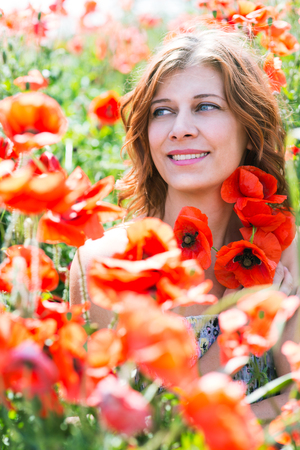 woman in field of red poppiesの写真素材