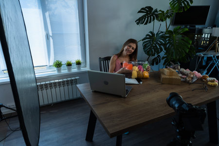 Young Beautiful Woman Leads Her Video Blog From Home And Writes Content About Unpacking New Received...