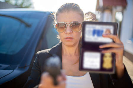 Special federal intelligence agent woman in black suit and big police carの写真素材