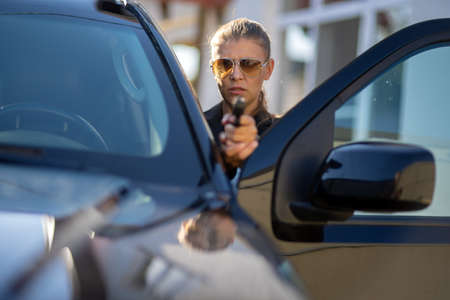 Special federal intelligence agent woman in black suit and big police carの写真素材