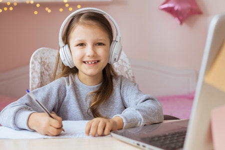 Schoolgirl Girl Studies Online On Laptop At Home. Communicate Online With Teacher. Teaching Lessons...