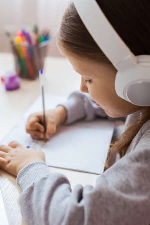 Schoolgirl Girl Studies Online On Laptop At Home. Communicate Online With Teacher. Teaching Lessons From School At Computer. Participates in distance education.の写真素材