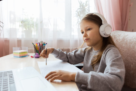 Schoolgirl Girl Studies Online On Laptop At Home. Communicate Online With Teacher. Teaching Lessons...