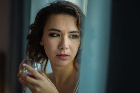 Drunk Woman In Depression Is In The Bedroom And Suffers From Anxiety Drinks Alcohol Wine Alone At Homeの写真素材