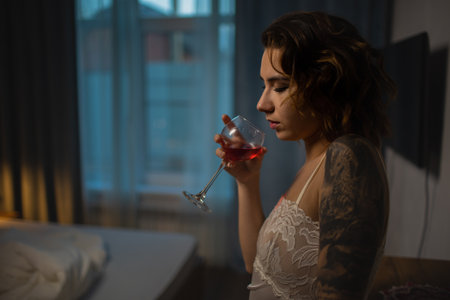 Drunk Woman In Depression Is In The Bedroom And Suffers From Anxiety Drinks Alcohol Wine Alone At Homeの写真素材