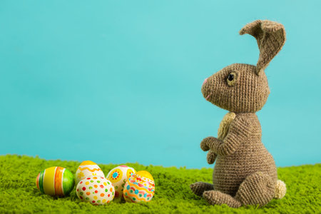 Easter background with cracked eggs green grass blue sky and easter bunnyの写真素材