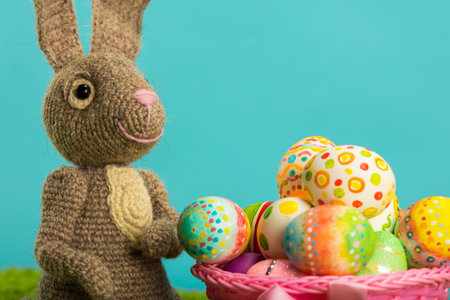 Easter background with cracked eggs green grass blue sky and easter bunny