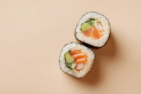 Three sushi rolls sit neatly on a simple background. Each roll contains fresh salmon and creamy avocado, showing vibrant colors. Perfect for sushi lovers.の素材