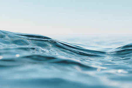 Gentle waves flow smoothly across the surface of the water, reflecting soft sunlight. The scene captures the peaceful essence of the ocean at mid-morning.の素材