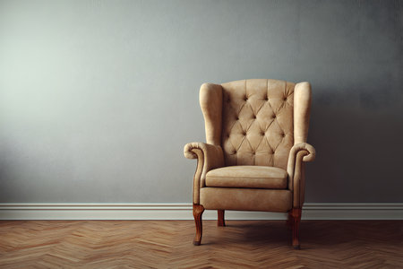 A soft, tufted armchair stands alone in a spacious living room. The hardwood floor features a herringbone pattern, and the wall is painted in a neutral shade, creating a calming atmosphere.の素材