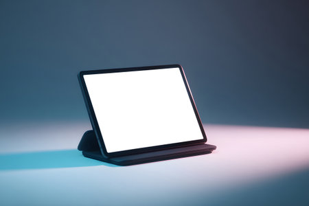 A sleek digital display stand is set on a flat surface, showcasing a blank screen. This setup is ideal for presentations or promotional displays in indoor environments.の素材