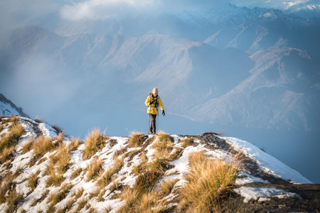 person hiking on snow at Roy peaks over Lake Wanaka, New Zealand