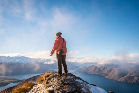 person at top of Roy's peak ,wanaka in new zealandの写真素材