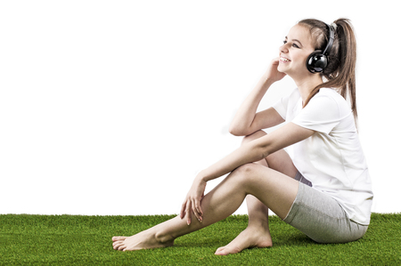Attractive girl listening to music after jogging. White backgroundの写真素材