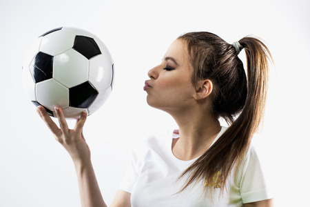 Beautiful girl kisses soccer ballの写真素材