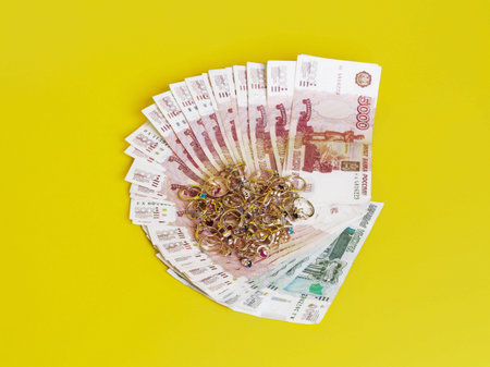 Jewelry are on banknotes. Yellow background.
